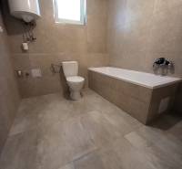 Bathroom in a family house with a bathtub, toilet, and boiler.