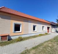 A family house in Trakovice with an orange facade and a red roof.