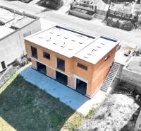 An unfinished family house in Trnové, Žilina, surrounded by a green plot and neighboring houses.