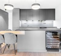 A kitchen in a 2-room apartment with stylish furniture and built-in appliances.