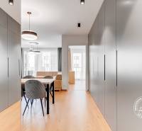 Interior of a 2-room apartment with a dining table, chairs, and cabinets in the hallway.
