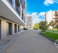 Exterior of a 3-room apartment in Bratislava on Seberíniho Street with garage doors.