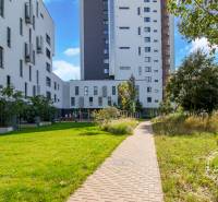 Apartment buildings on Seberíniho Street in Bratislava - Ružinov with a park and a walkway.
