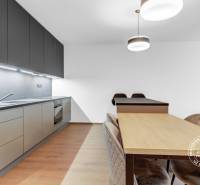 Kitchen in a 2-room apartment with a modern kitchen unit, dining table, and chairs.