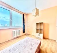 A bright room with a bed and a cabinet in a 3-room apartment.