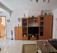 Living room with furniture and decorations in a cabin, comfortable seating and a dining area.