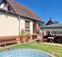 A cottage in Senec with a terrace, gazebo, and pool in a landscaped garden.