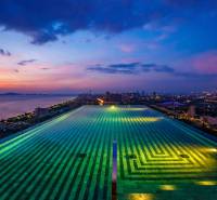 A view of the rooftop pool overlooking the evening skyline of Pattaya.