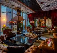 Luxury living room interior with leather furniture and a sunset view.