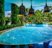 Luxury pool with green plants and lamps, Apartment construction in Pattaya.