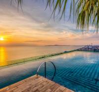 Apartment construction in Pattaya at sunset with a view of the infinity pool.