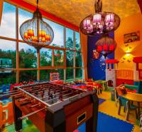 Children's playroom with a football table and indoor games in apartment construction.