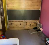 Children's room in a 3-room apartment with colorful walls and storage space.
