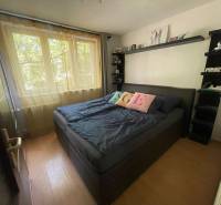 A bedroom with large windows and a bed in a 3-room apartment.