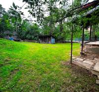 The garden of a family house in Veľká Lesná with a wooden gazebo and lawn.