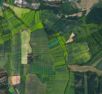 Aerial view of agricultural and forest lands around Sučany, various fields and green zones.