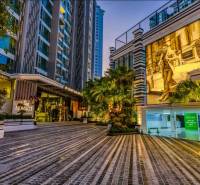 Night architecture during apartment construction in Pattaya with illuminated street and vegetation.