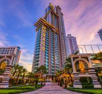The Monaco skyscraper in the center of residential development in the city of Pattaya, surrounded by palm trees.