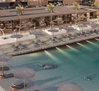 Luxury pool and beach loungers in front of a family house on the coast.