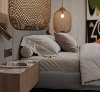 Bedroom in a family house with a bed, nightstand, and hanging lamps.