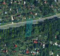Satellite image of agricultural and forest lands in Prievidza with prominent parcel lines.