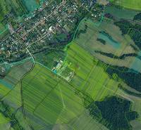 Ladomirová with agricultural and forest lands, showing the village and surrounding fields.