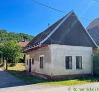 A family house in Banská Bystrica with a traditional gable roof, surrounded by nature.