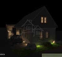 A night view of a family house in Banská Bystrica with an illuminated garden and staircase.