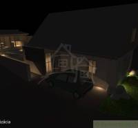 A night view of a family house in Banská Bystrica with illuminated exterior.