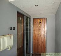 Entrance hallway in a family house with wooden doors and a radiator.