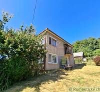 A family house in Lovinobaňa with a large garden and a wooden gazebo in the background.