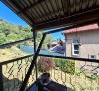 A family house in Lovinobaňa with a terrace, overlooking the garden and surrounding trees.