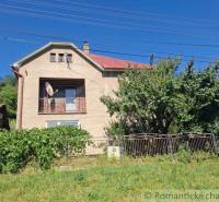 Family house in Lovinobaňa, brick facade, satellite dish, garden, and fence.
