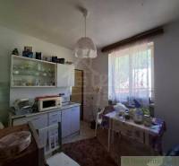 Traditional kitchen with furniture and dining area in a family house.