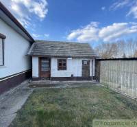 Exterior of a family house in Nové Zámky with an adjoining extension and fencing.