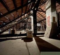 Attic space of a family house with a beam ceiling and reinforced columns.