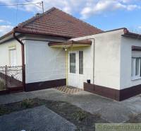 A family house in Nové Zámky with a white facade and a pitched roof.