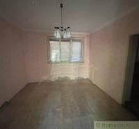 Empty room with wooden floor, light, and a window in a family house.