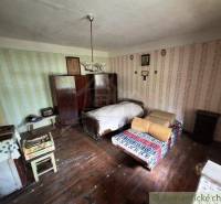 A retro room in a family house with two beds and a wooden floor.