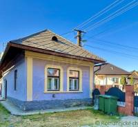 A family house in Gemerská Poloma with a blue facade and windows framed in yellow.