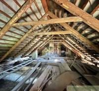 The attic of a family house full of wooden beams and building materials.