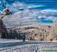 Snow-covered slopes and a ski lift in winter surrounded by forests in Stará Myjava.