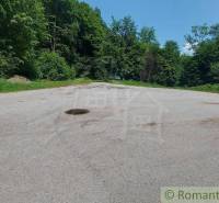 Asphalt area surrounded by forest in Stará Myjava, suitable for commercial spaces.