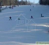 Skiers on the snowy slope in Stará Myjava with awarded slopes.