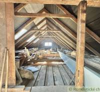 The attic of a family house with an old wooden frame and storage space.