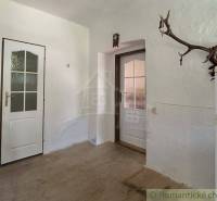 White room with two doors and antlers in a family house.