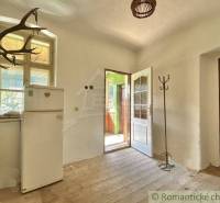 Interior of a family house with antique elements and simple furnishings.