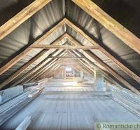 Attic in a family house with wooden beams without attic conversion.