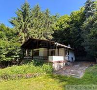 A family house in Malacky surrounded by dense forests and grassy environment.