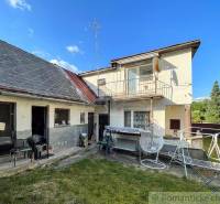 Family house in Sielnica, garden with terrace, clothesline, hanging chair, blue sky.